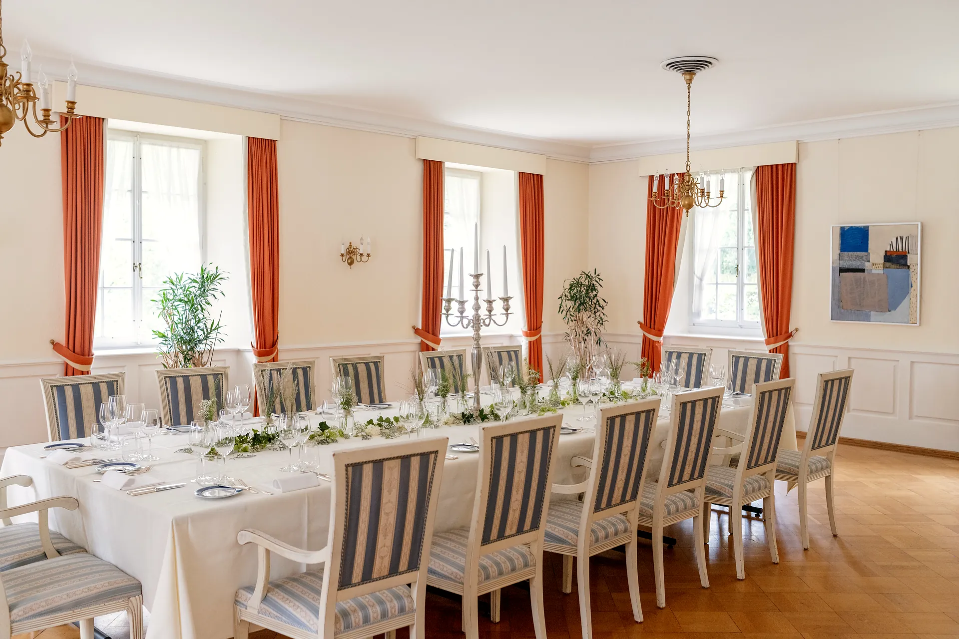 Grosser Saal mit langer Tafel und hohen Fenstern